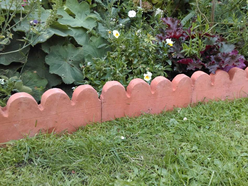 Alacsony kerámia kerítés a kertben