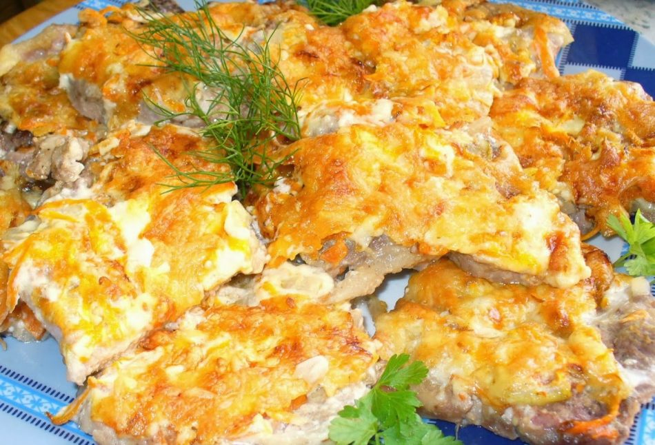 Meat baked in the oven with mayonnaise, cheese