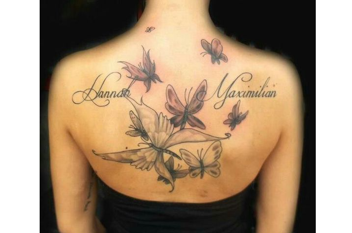 Tattoo on a shoulder blade for girls with inscriptions