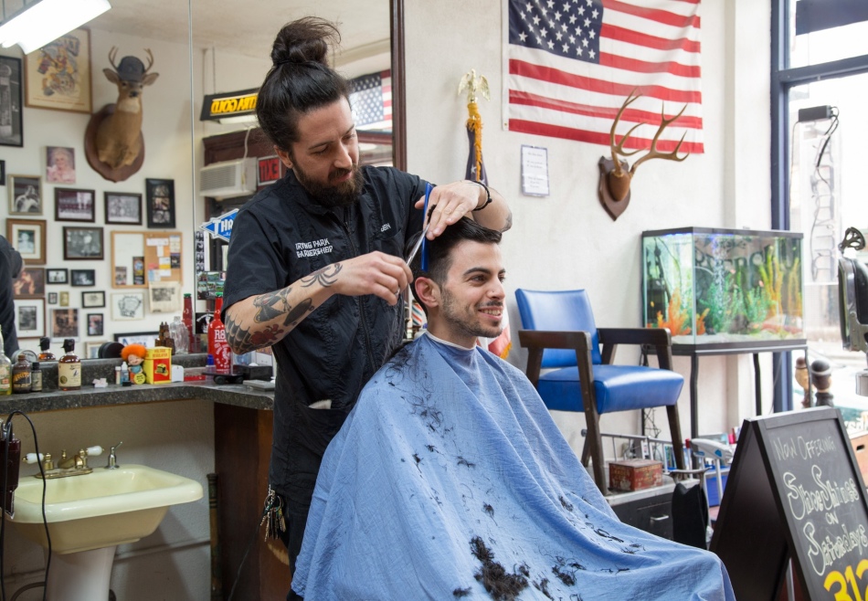 Barber performs a haircut