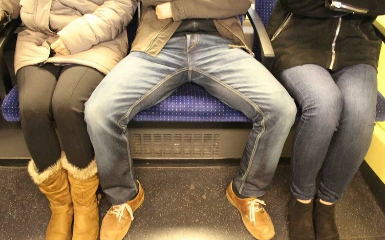 Almost all men are sitting with their legs arranged