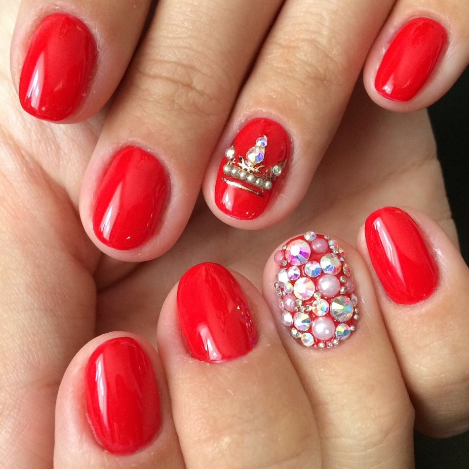 Red manicure with crown