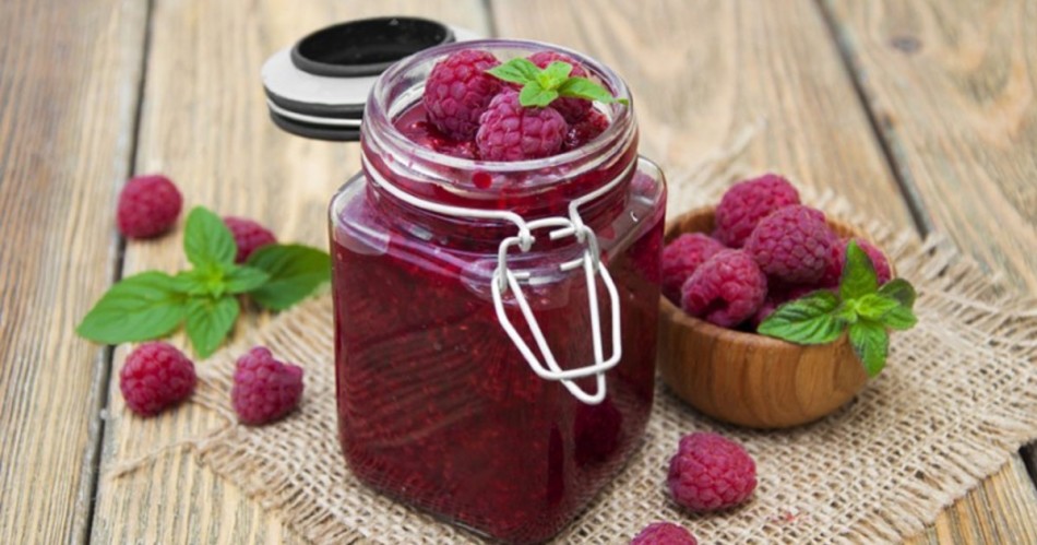 Fragrant raspberry jam with mint on a table in a jar
