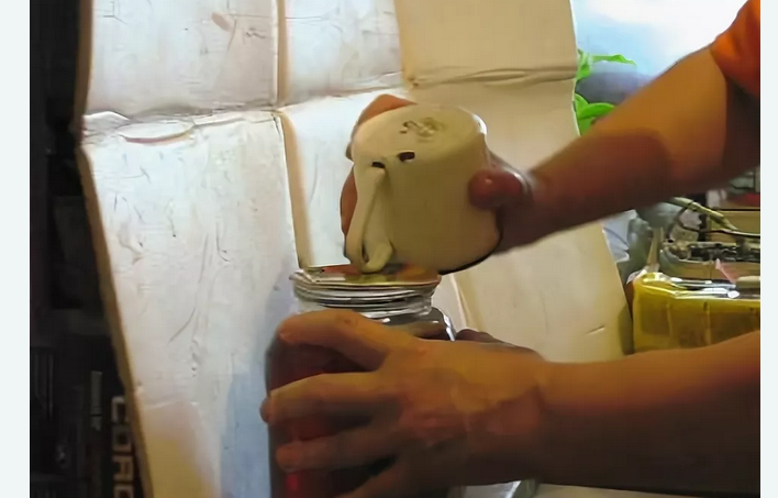 A rolled jar can be opened without an opener with an iron mug